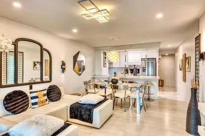a living room with a couch and a dining room at Art Deco Broadway Queen Room in Vancouver