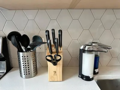 a kitchen counter with a knife block and utensils at K202 Hot tub, Pool, MTN view, AC, free parking in Canmore