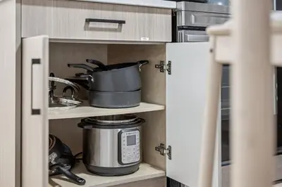 a kitchen pantry with a pot on a shelf at NEST- Modern 2BR Basement Retreat in South Surrey in Surrey