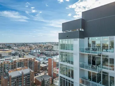 a tall building with a view of a city at Studio Just Steps from Stampede Park, Luxury Living in Calgary