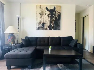 a living room with a couch and a table at Entire Apartment Prime Downtown location Free underground Parking in Calgary