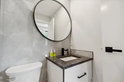 a bathroom with a white toilet and a mirror at The Oak Hotel in Nelson