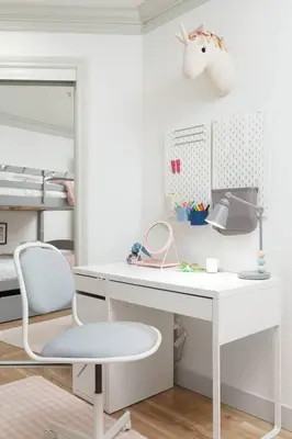 a white desk with a chair and a bed at Boutique Beach Apartment in Vancouver