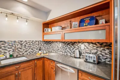 a kitchen with wooden cabinets and a sink at The Crest, Spacious, Central Condo, Free Parking in Whistler