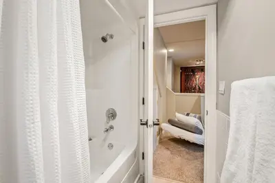 a white bathroom with a shower and a tub at The Crest, Spacious, Central Condo, Free Parking in Whistler