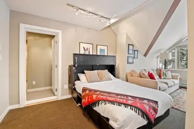 a bedroom with a bed and a couch at The Nest, Central, Luxury Unit, Free Parking in Whistler