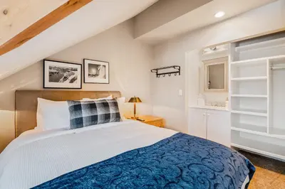 a bedroom with a large bed with a blue blanket at The Nest, Central, Luxury Unit, Free Parking in Whistler