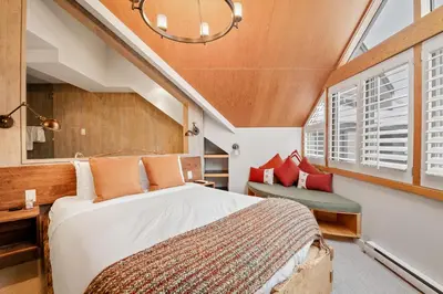 a bedroom with a large bed and a window at The Den, Heart of Village, Free Parking in Whistler