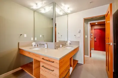 a bathroom with a sink and a large mirror at The Den, Heart of Village, Free Parking in Whistler