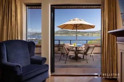 a patio with a table and chairs and an umbrella at The Royal Kelowna - Bellstar Hotels & Resorts in Kelowna