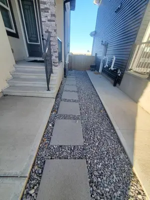 a house with a walkway next to a building at Charming 2-Bedroom Basement Oasis Sleeps 5,Size-150sqm, Netflix, family friendly in Edmonton