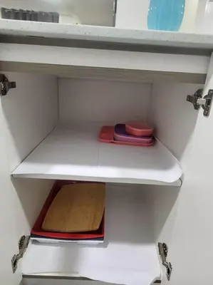 a white shelf in a kitchen with some bowls on it at Charming 2-Bedroom Basement Oasis Sleeps 5,Size-150sqm, Netflix, family friendly in Edmonton