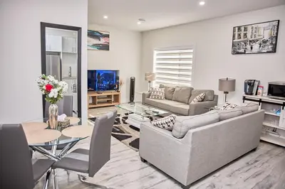 a living room with a couch and a table at Brand-new three bedroom guest suite in the desirable neighbourhood in Prince George