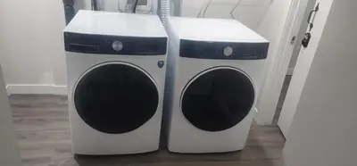 a washer and dryer sitting next to each other at A Cozy home away from home at South East Calgary in Calgary