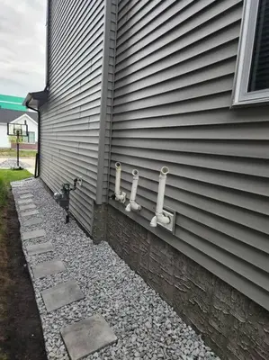 a side of a house with pipes on the side of it at Modern 2 Bedroom Basement Suite Chappelle Edmonton in Edmonton