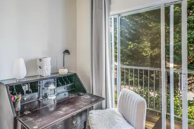 a room with a desk and a balcony with a window at Entire home minutes from 3 lakes and a river! in Nanaimo