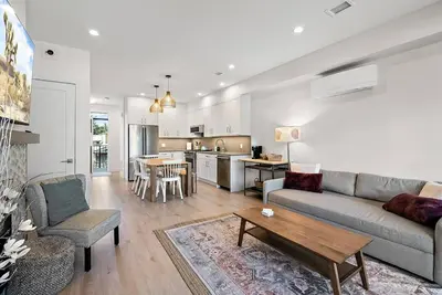 a living room with a couch and a table at The Beach House at Saratoga Oceanfront Escape in Oyster Bay
