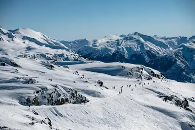 a group of people skiing down a snow covered mountain at Creekside Oasis 4 Beds Pool and Hot Tub in Whistler