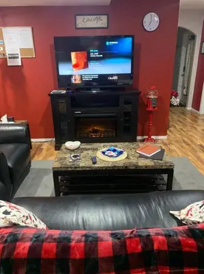 a living room with a couch and a television at Cozy Lodge Suite in Sylvan Lake