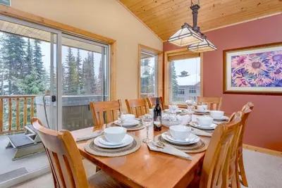 a dining room with a wooden table and chairs at Best Ski-in out 3 Bdrm Chalet, with Hot Tub in Big White
