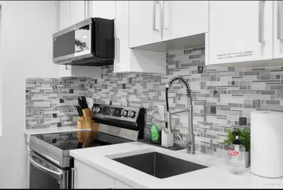 a kitchen with a sink and a counter top at Entire new small home in Vancouver
