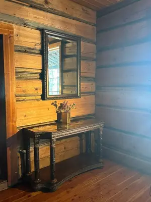 a wooden room with a table with a window at Rustic Beaverfoot Lodge Room N3 in Parson