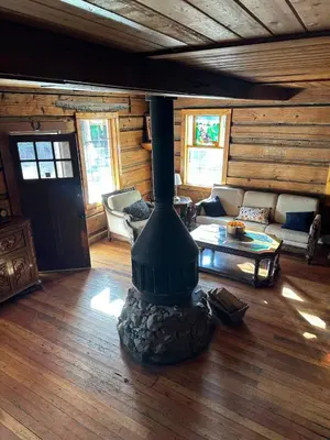 a living room with a fireplace in a cabin at Rustic Beaverfoot Lodge Room N4 in Parson