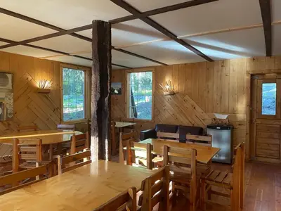 a dining room with wooden tables and chairs at Rustic Beaverfoot Lodge Room N4 in Parson