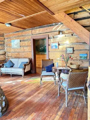 a living room with a table and chairs and a couch at Rustic Beaverfoot Lodge Room N5 in Parson