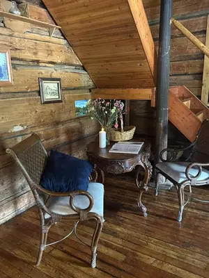 a room with a table and chairs in a cabin at Rustic Beaverfoot Lodge Room N5 in Parson