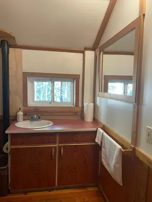 a bathroom with a sink and a mirror at Rustic Beaverfoot Lodge Room N5 in Parson