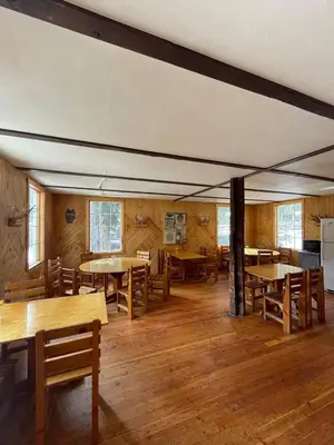 a dining room with wooden tables and chairs at Rustic Beaverfoot Lodge Room N5 in Parson