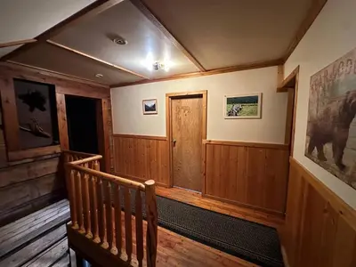 a room with a wooden staircase with a wooden door at Rustic Beaverfoot Lodge Room N6 in Parson