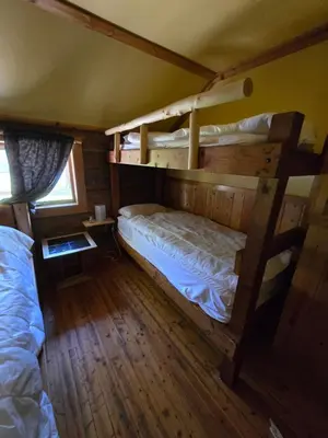 a bedroom with two bunk beds in a cabin at Rustic Beaverfoot Lodge Room N8 in Parson