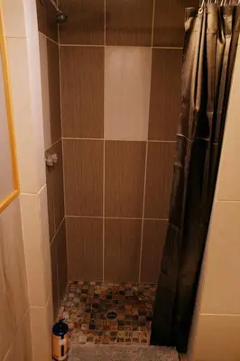a bathroom with a shower with a shower curtain at Rustic Beaverfoot Lodge Room N8 in Parson