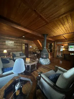 a living room with a fireplace in a log cabin at Rustic Beaverfoot Lodge Room N8 in Parson
