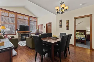 a living room with a table and chairs and a couch at Settler's Crossing #56 ski-in ski-out condo with private hot tub in Sun Peaks