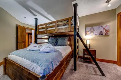 a bedroom with a bunk bed in a room at Greystone Lodge 320 Ski-in Out in Whistler