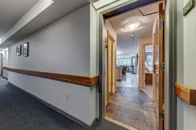 a hallway with a door leading into a room at Greystone Lodge 332 Ski-in Out in Whistler