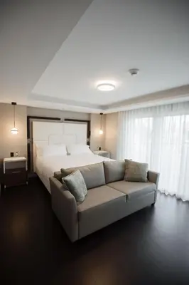a large bedroom with a bed and a couch at the reid hotel in Vanderhoof