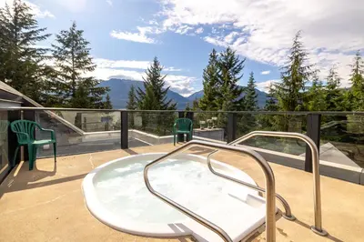 a hot tub on the balcony of a house at Powderhorn at Whistler Blackcomb in Whistler
