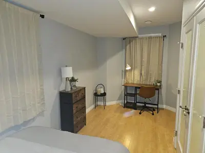 a bedroom with a bed and a desk in it at River Valley Suite Near Downtown in Edmonton