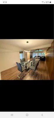 a living room with a glass table and chairs at Farmestate in Vancouver