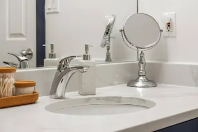 a bathroom counter with a sink with a mirror at Reach Your Peak, Ski In, Ski Out, Pool, Hot Tub in Panorama
