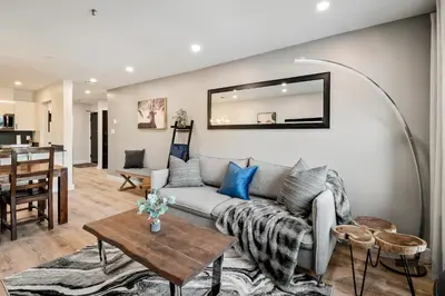 a living room with a couch and a table at Ski In & Out, Heart of Upper Village in Whistler