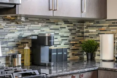 a kitchen with a stove top oven in a kitchen at Large House Near Calgary Airport with Central AC, Double Car Garage Parking, Upgrade Stay, Netflix, Sleeps 8 in Calgary