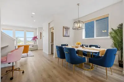 a dining room with a table and blue chairs at Entire 4 Bedroom House Including Basement with King Size Bed, Upgrade Your Stay, Netflix, Sleeps 14 in Balzac