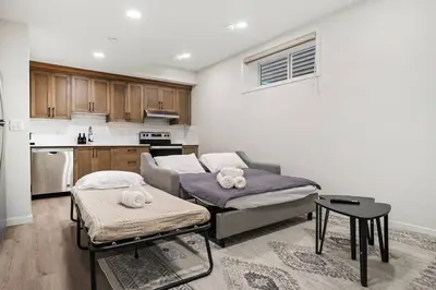 a living room with a couch and a table at Entire 4 Bedroom House Including Basement with King Size Bed, Upgrade Your Stay, Netflix, Sleeps 14 in Balzac
