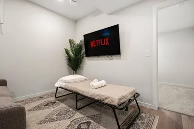 a living room with a tv on a wall at Entire 4 Bedroom House Including Basement with King Size Bed, Upgrade Your Stay, Netflix, Sleeps 14 in Balzac