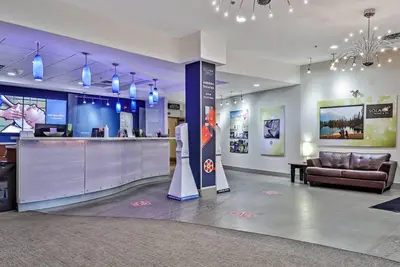 a lobby with a bar and a couch in a room at L109 Canmore World Class Solara Resort - Hot tub, Pool, Gym, AirCon, Free Parking & Netflix in Canmore